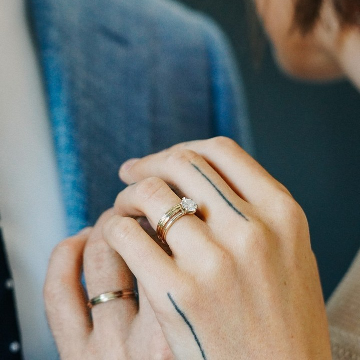 Helga and Peter's hands grasping eachother showing off both of their wedding bands and Helga's engagement ring on their wedding day.