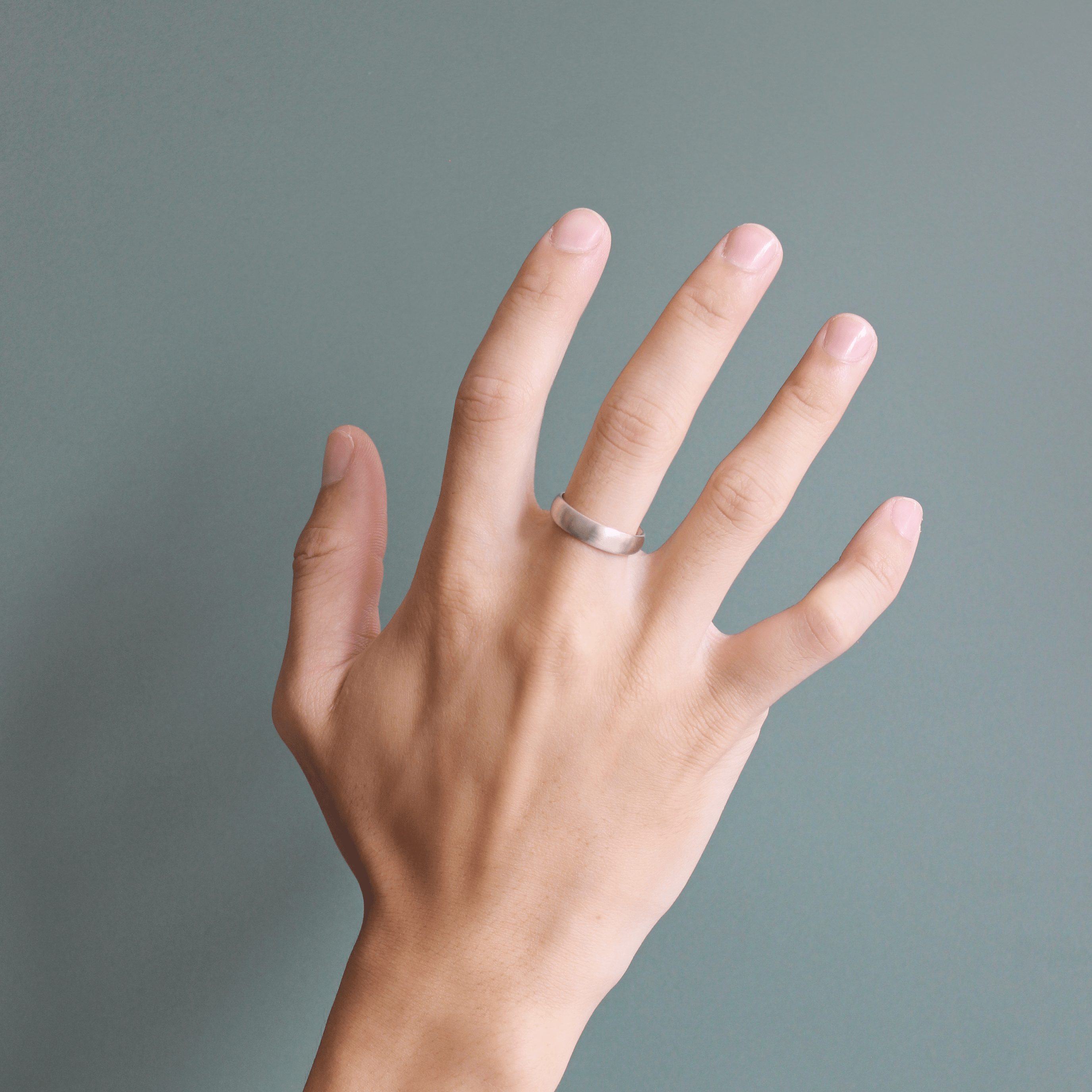 Model wears Ellipse Band 4mm in 14k White Gold with Concrete Finish