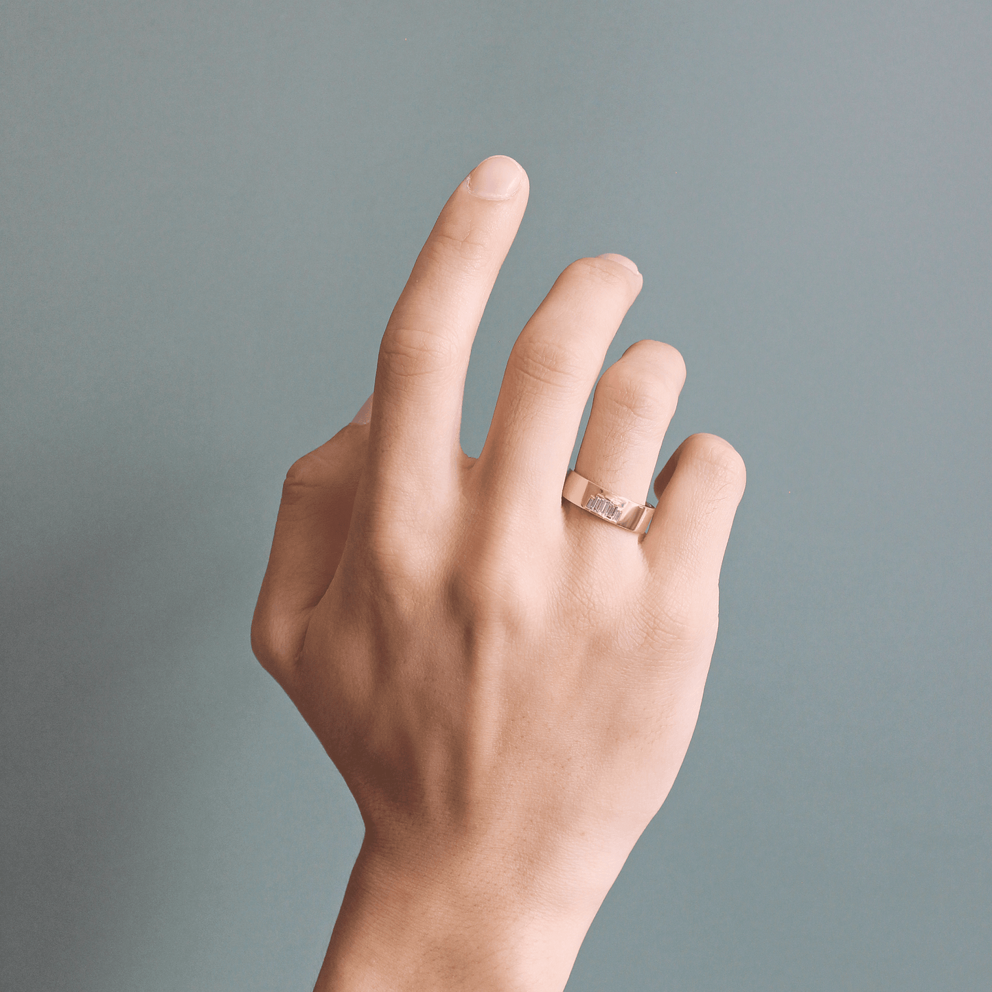 Model wearing Horizon Band / Step Lab Baguette Diamonds on ring finger