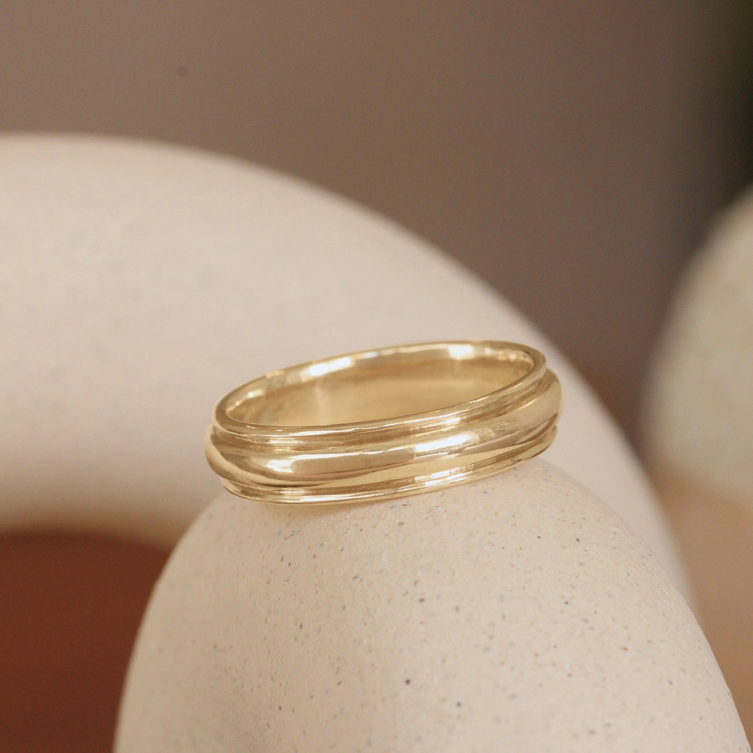 Lifestyle angled view of Cornice Band Wide in 14k yellow gold