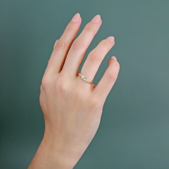Model wearing Ellipse Band / Medium + Diamonds on ring finger