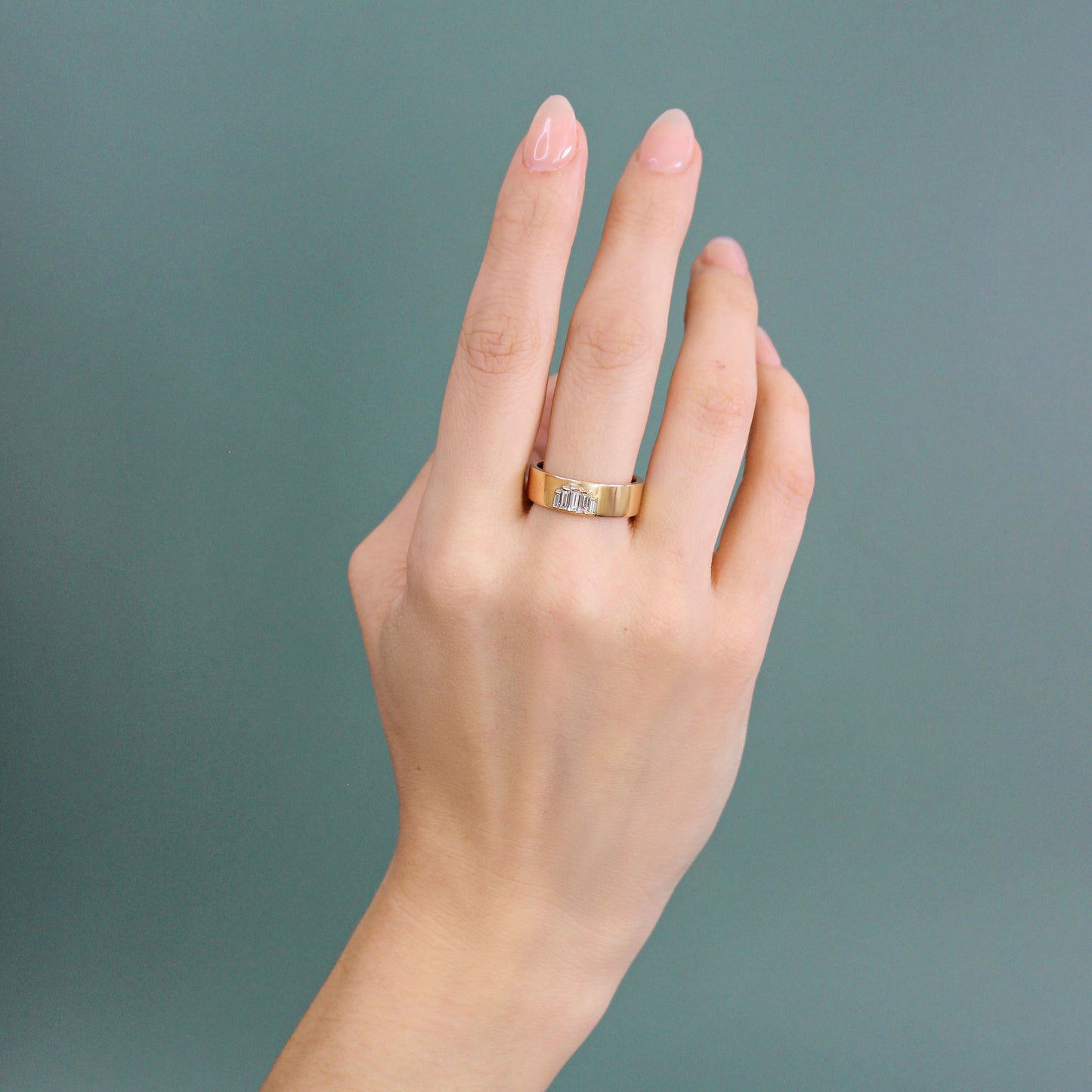 Model wearing Horizon Band / Step Lab Baguette Diamonds on middle finger