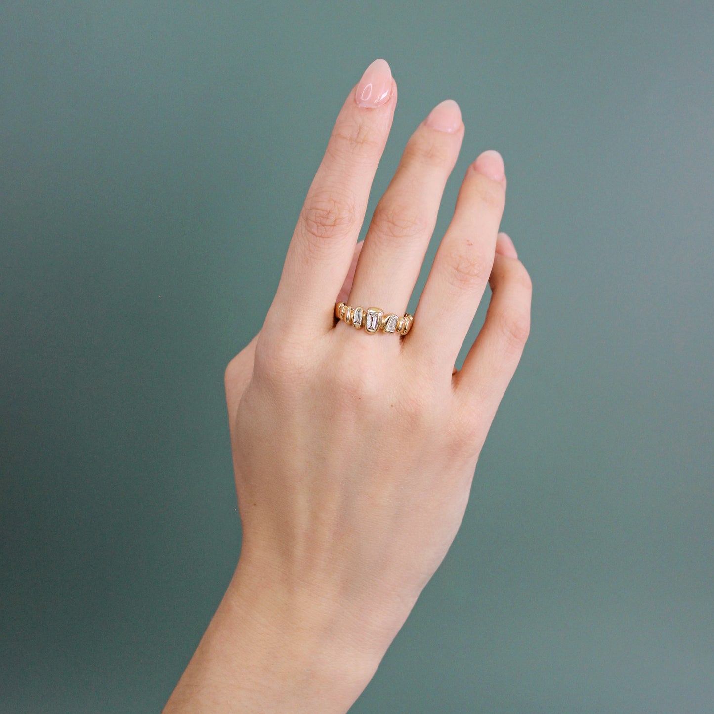 Model wears Ruins Band / Medium + Lab Baguette Diamonds on middle finger