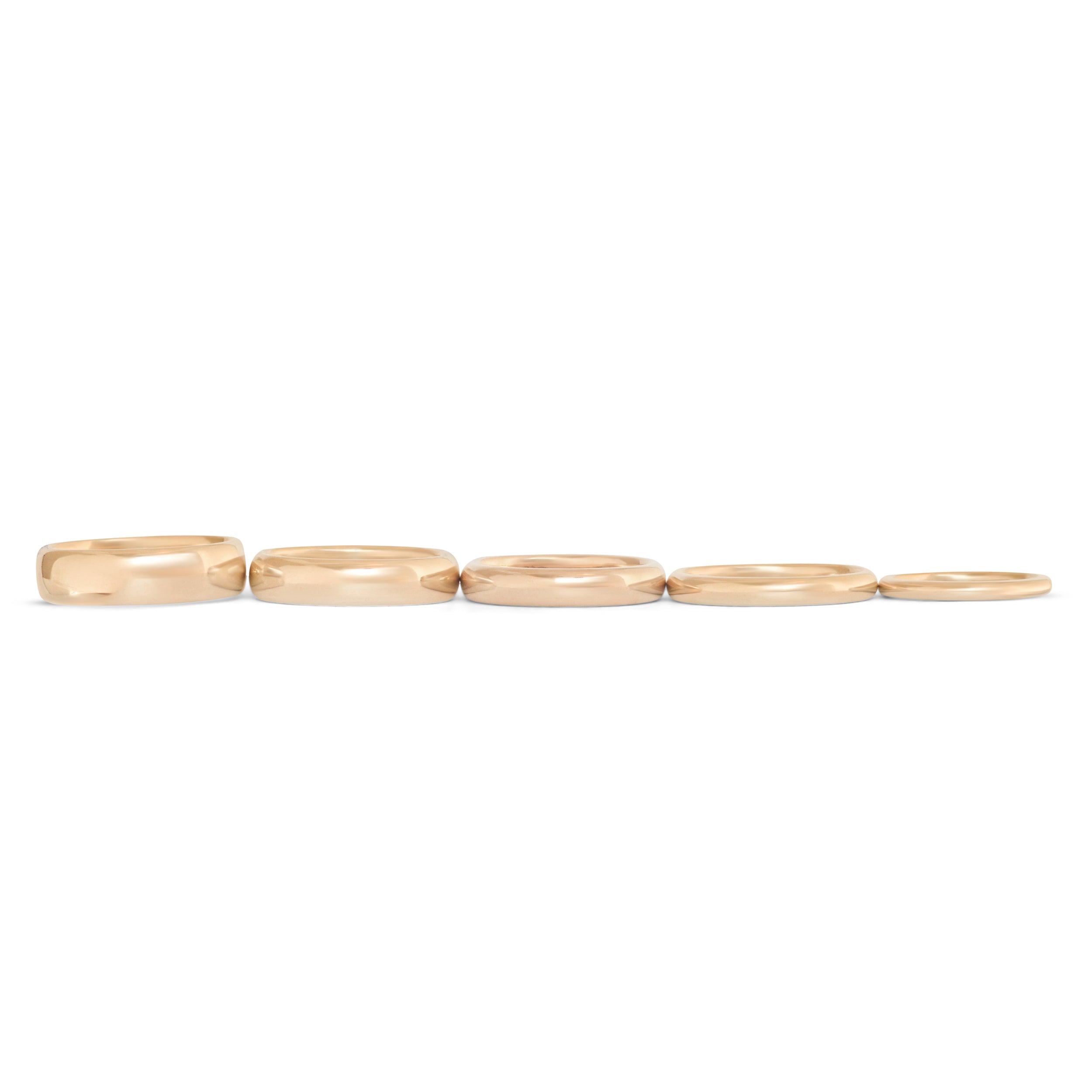 Lined up view of our Thick Dome Bands in various widths in 14k yellow gold