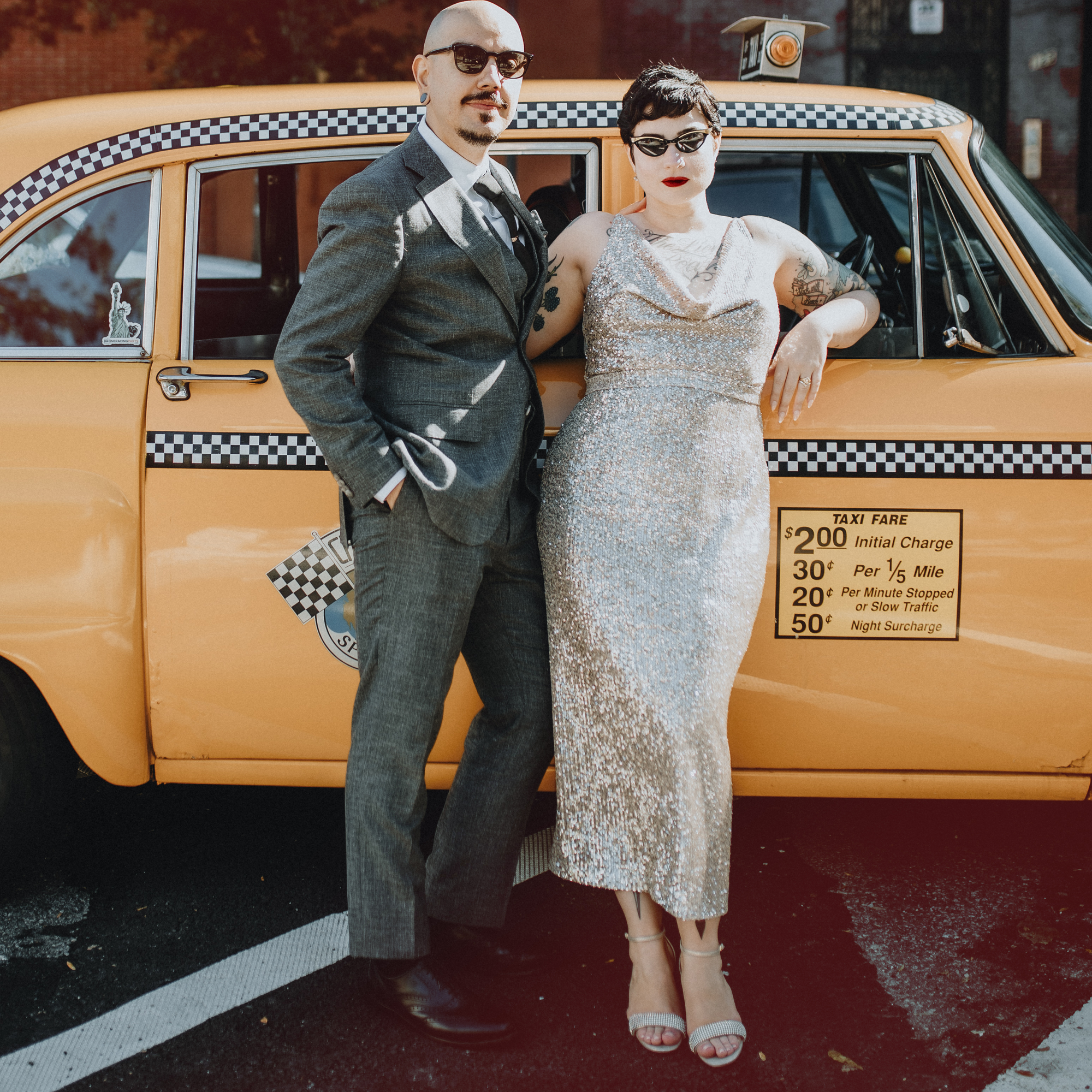 Aly and Daniel posed in front of a vintage taxi cab on their wedding day.