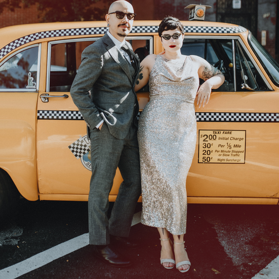 Aly and Daniel posed in front of a vintage taxi cab on their wedding day.