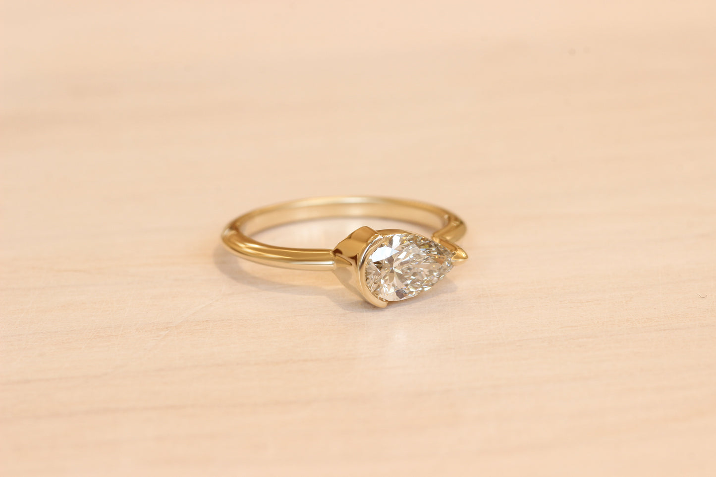Pear white diamond horizontally set in clients recycled yellow gold