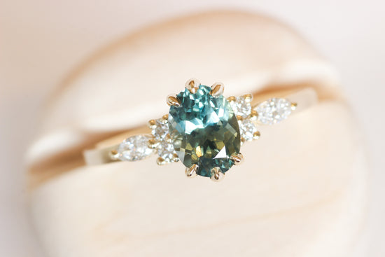Blue green Montana sapphire with side white diamonds