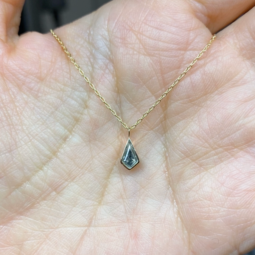 Meg and Zac's custom kite salt and pepper diamond yellow gold necklace made at Goldpoint Jewelry.