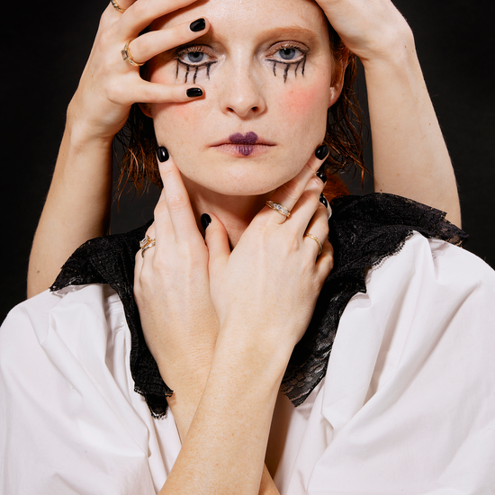 Model wears mixed rings and bands from our Cornice Collection