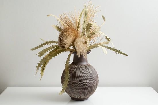 Ali Gibbons ceramic vase with flowers in it