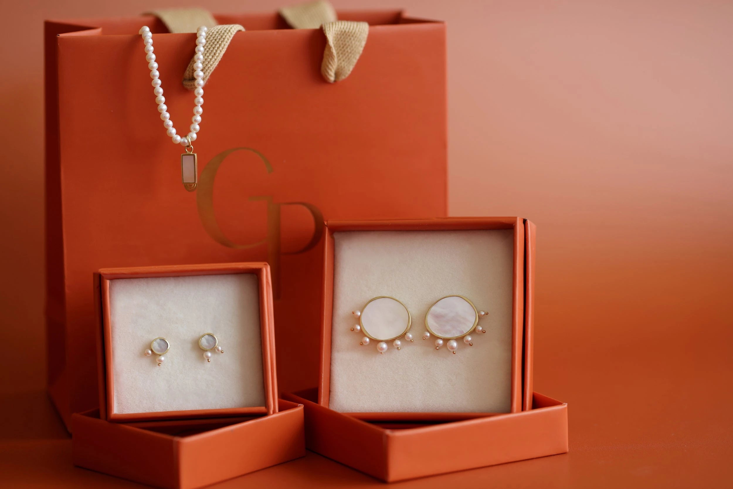 Two ring boxes holding from the Gifts Under $1000 Collection