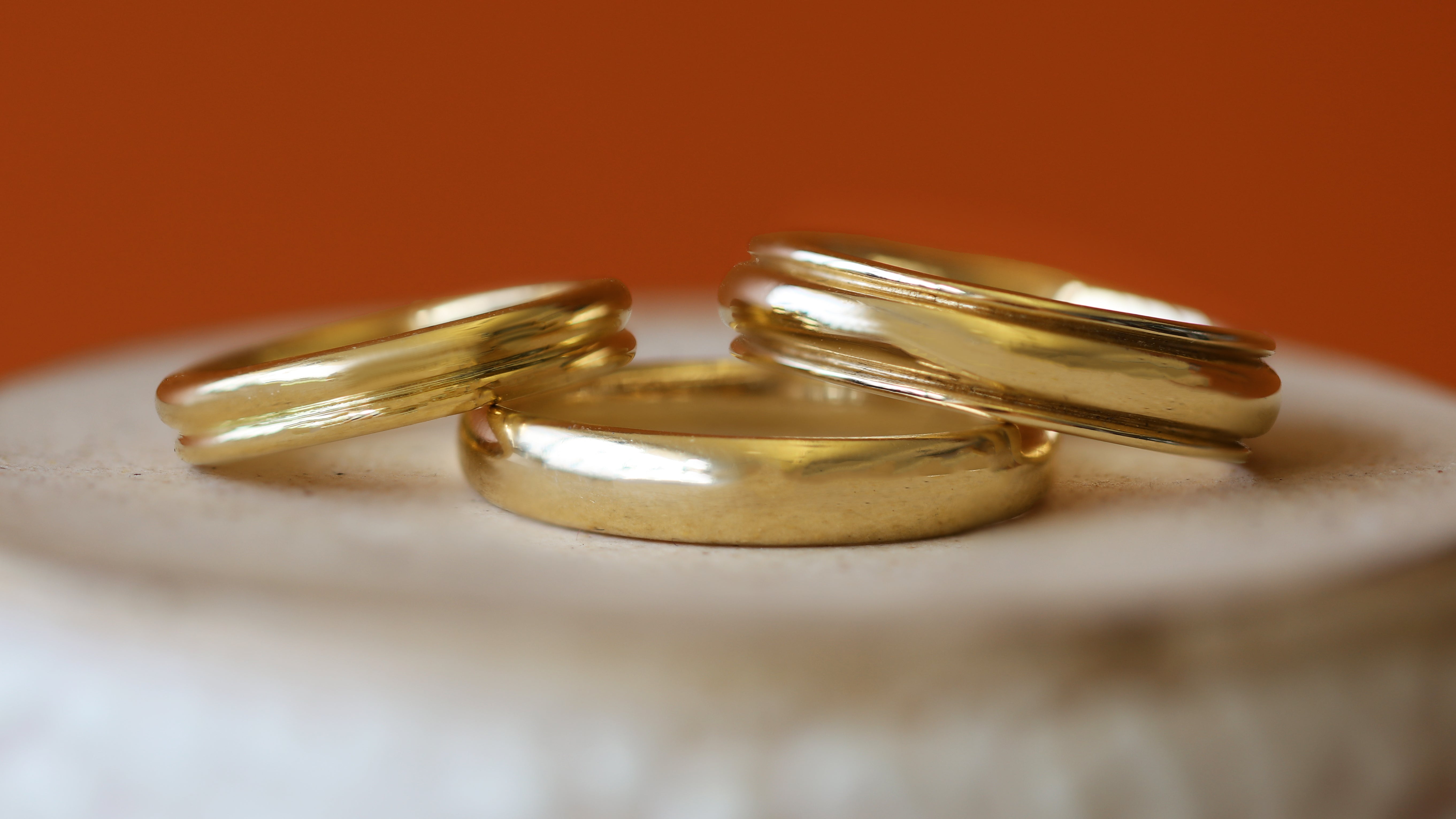 Stacked view of Thick Dome Band 4mm in Yellow Gold, Duo Band, and Cornice Band Wide in Yellow Gold 
