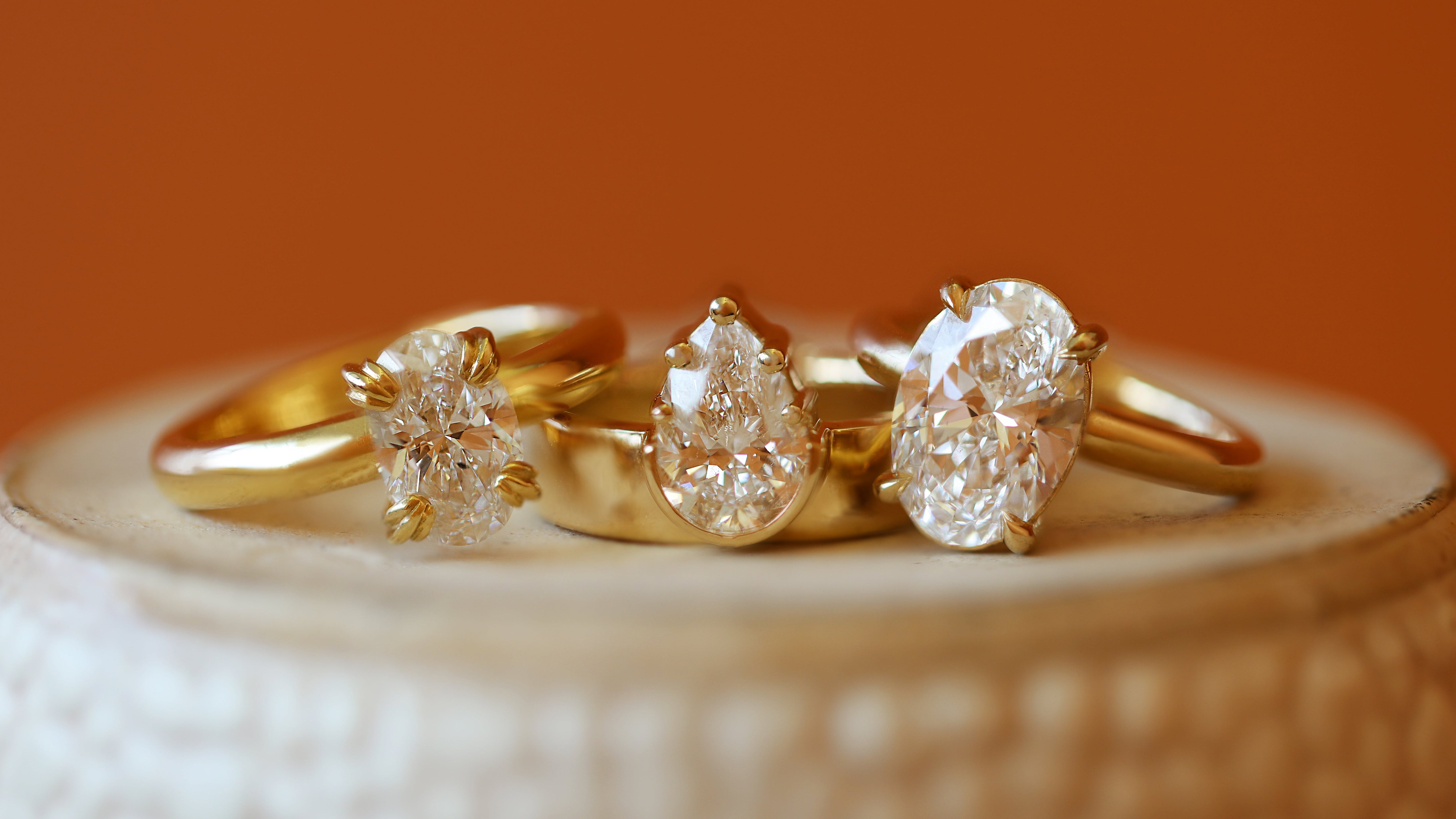 Stacked view of Calyer Ring Oval Lab Diamond 1.56ct, Varick Ring Pear Lab Diamond 1.55ct, and Noble Ring Oval Lab Diamond 3.01ct