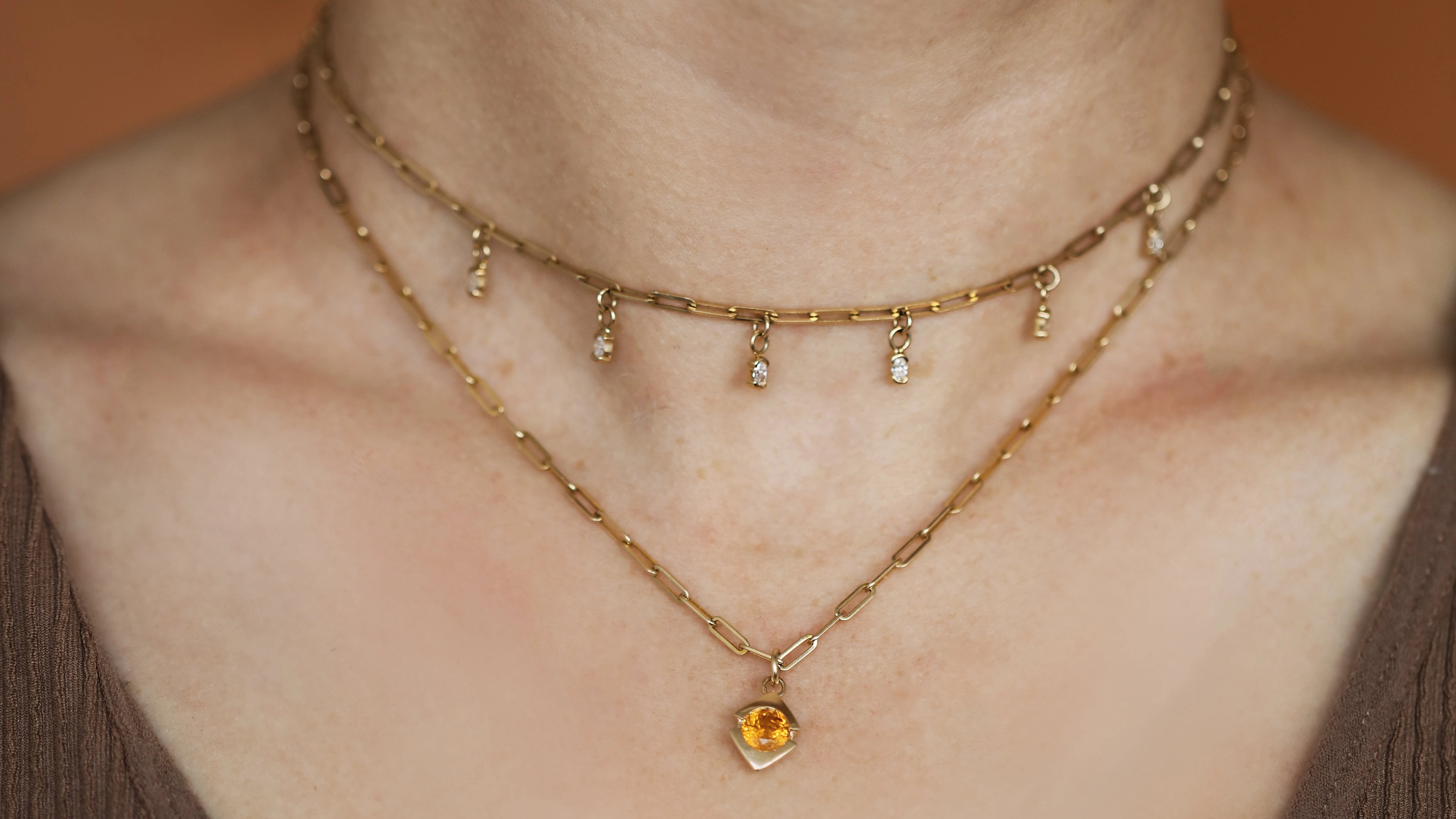 Model wears two pieces from the necklaces collection by Goldpoint