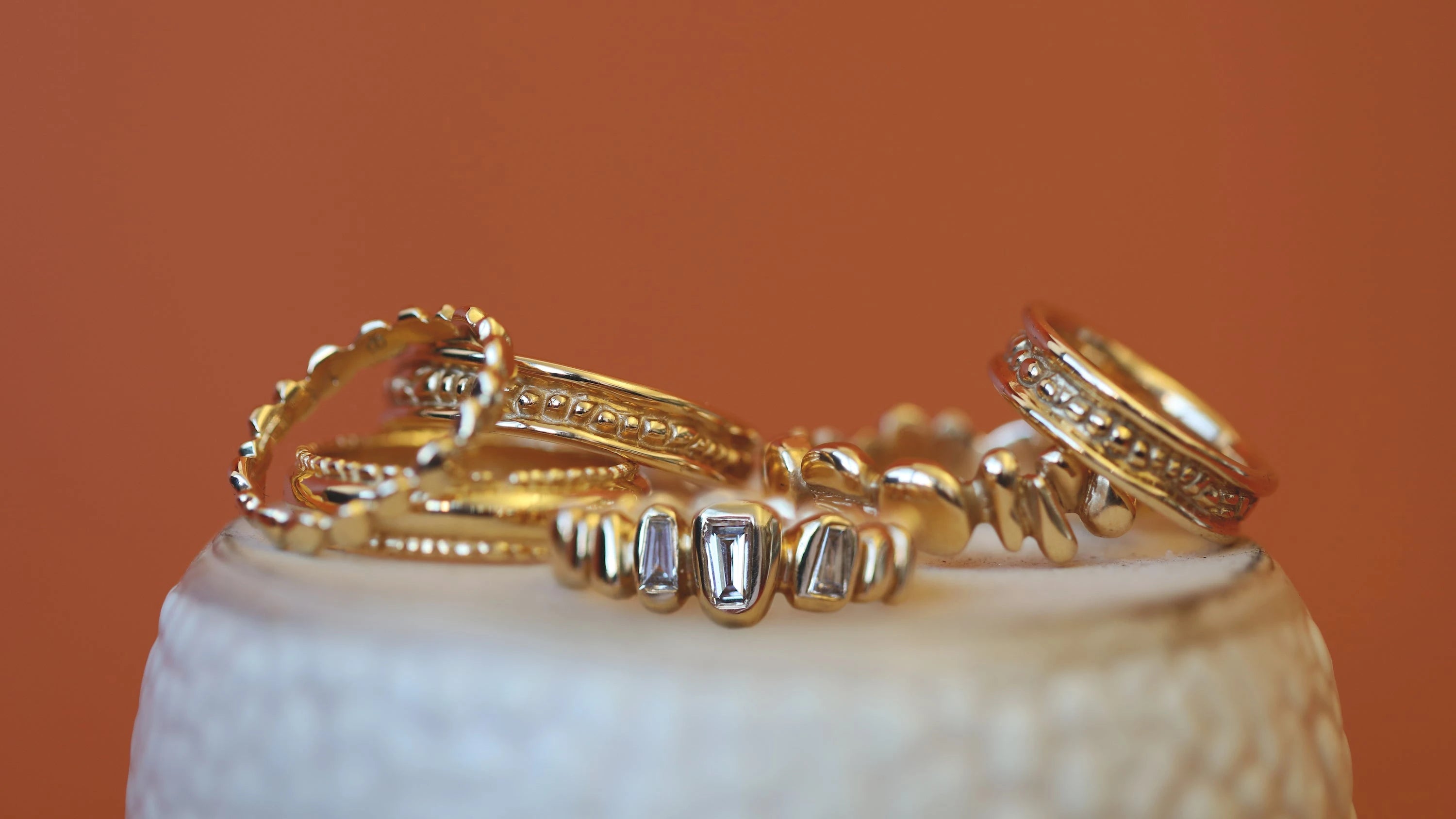 Lifestyle shot of a stack of rings from the Ruins Collection by Goldpoint