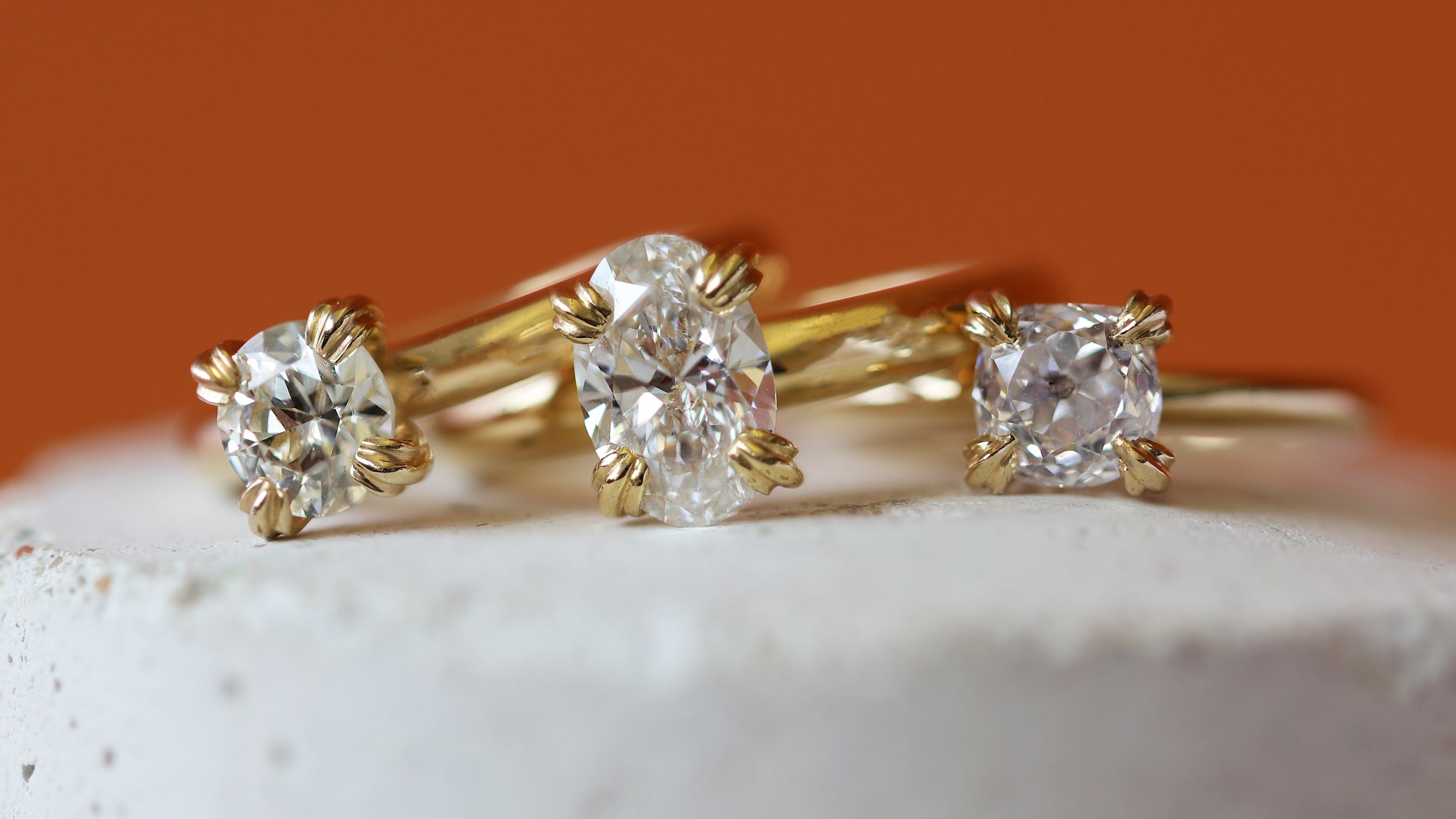 Artistic stacked view of Calyer Ring Old Mine Natural Diamond 1.28ct, Calyer Ring Oval Lab Diamond 1.56ct, and Calyer Ring Old Euro Natural Diamond 1.03ct from the Calyer Collection