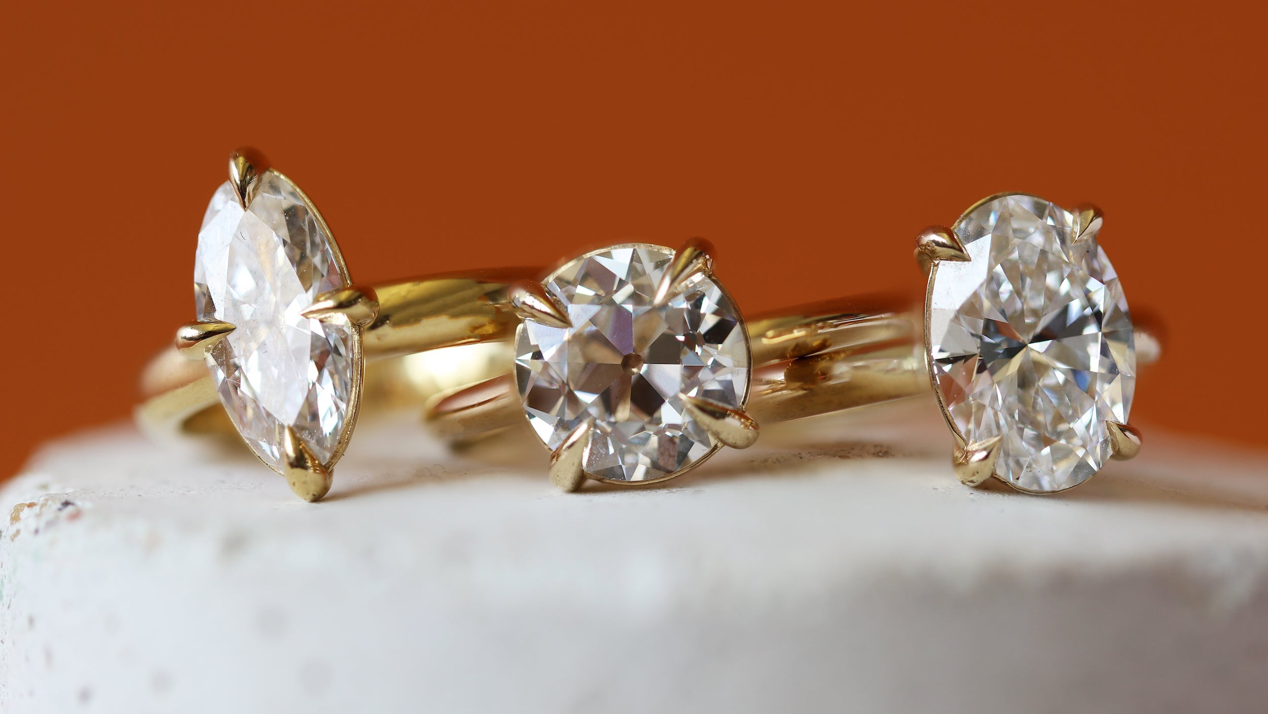 Stacked view of three engagement rings from the Noble Collection