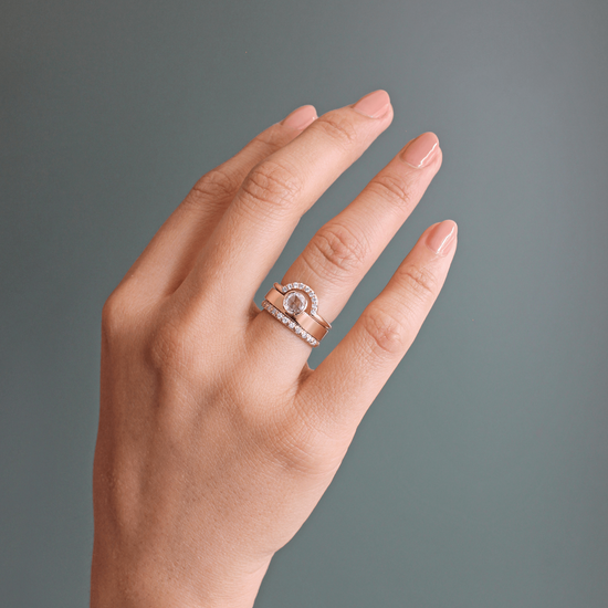 Model wearing a stack of matrimony pieces on ring finger featuring Dome Band / French Pave Diamonds