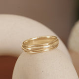 Lifestyle angled view of Cornice Band Wide in 14k yellow gold