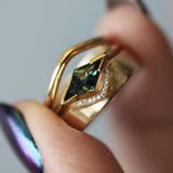 Model holds Dome Band Deep Curve in 14k yellow gold stacked with Horizon Band Triangle Cutout Pave Round Diamonds in 14k yellow gold and an engagement ring by Goldpoint