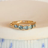 Lifestyle angled view of Cloud 5 Band Oval Sapphires in 14k yellow gold