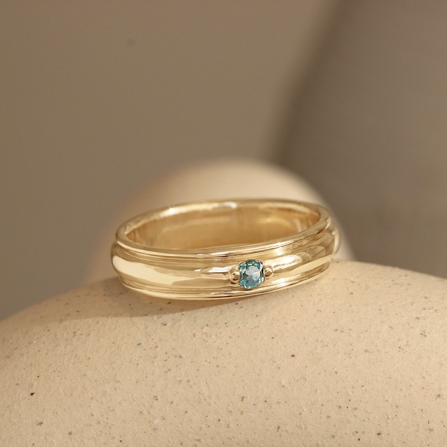 Lifestyle angled view of Cornice Band Wide Bead Round Sapphire in 14k yellow gold