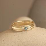 Lifestyle angled view of Cornice Band Wide Bead Round Sapphire in 14k yellow gold