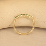 Lifestyle side profile view of Cloud 7 Band Curve Round Emeralds in 14k yellow gold