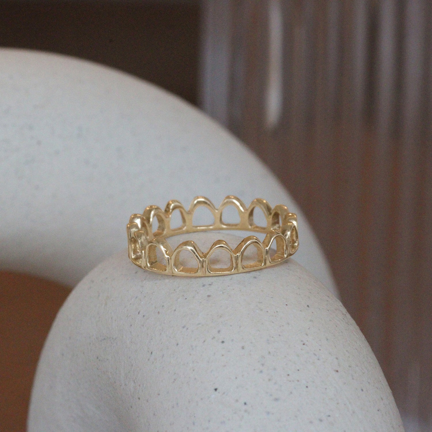 Lifestyle angled view of Arco Ring by Mon Pilar on a ceramic with blurred background