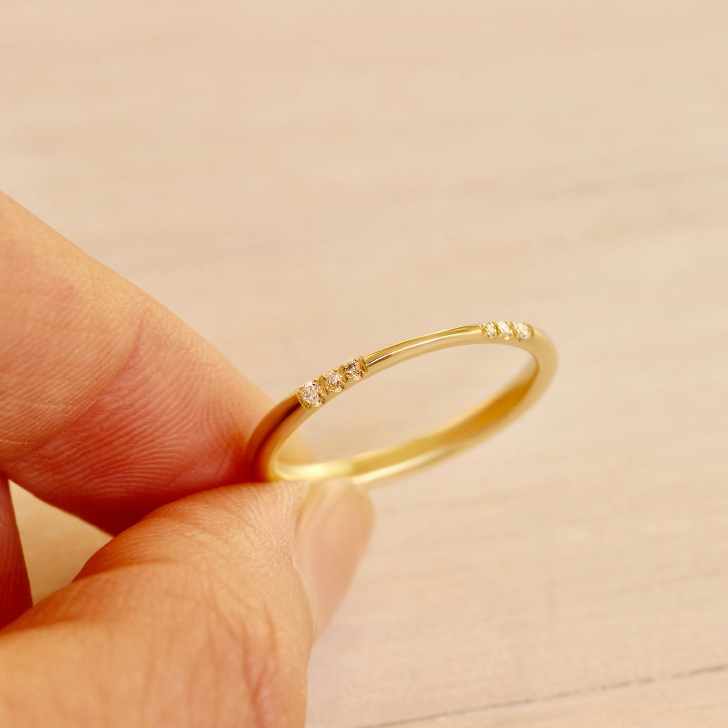 Hand holding Cinch Band / Lab Diamonds showing front view and inside of back of the band