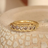 Lifestyle angled view of Cloud 7 Band Round Champagne Diamonds in 18k yellow gold