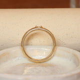 Lifestyle side profile view of Cornice Band Wide / Bead Round Lab Diamond in Yellow Gold by Goldpoint Jewelry on a ceramic