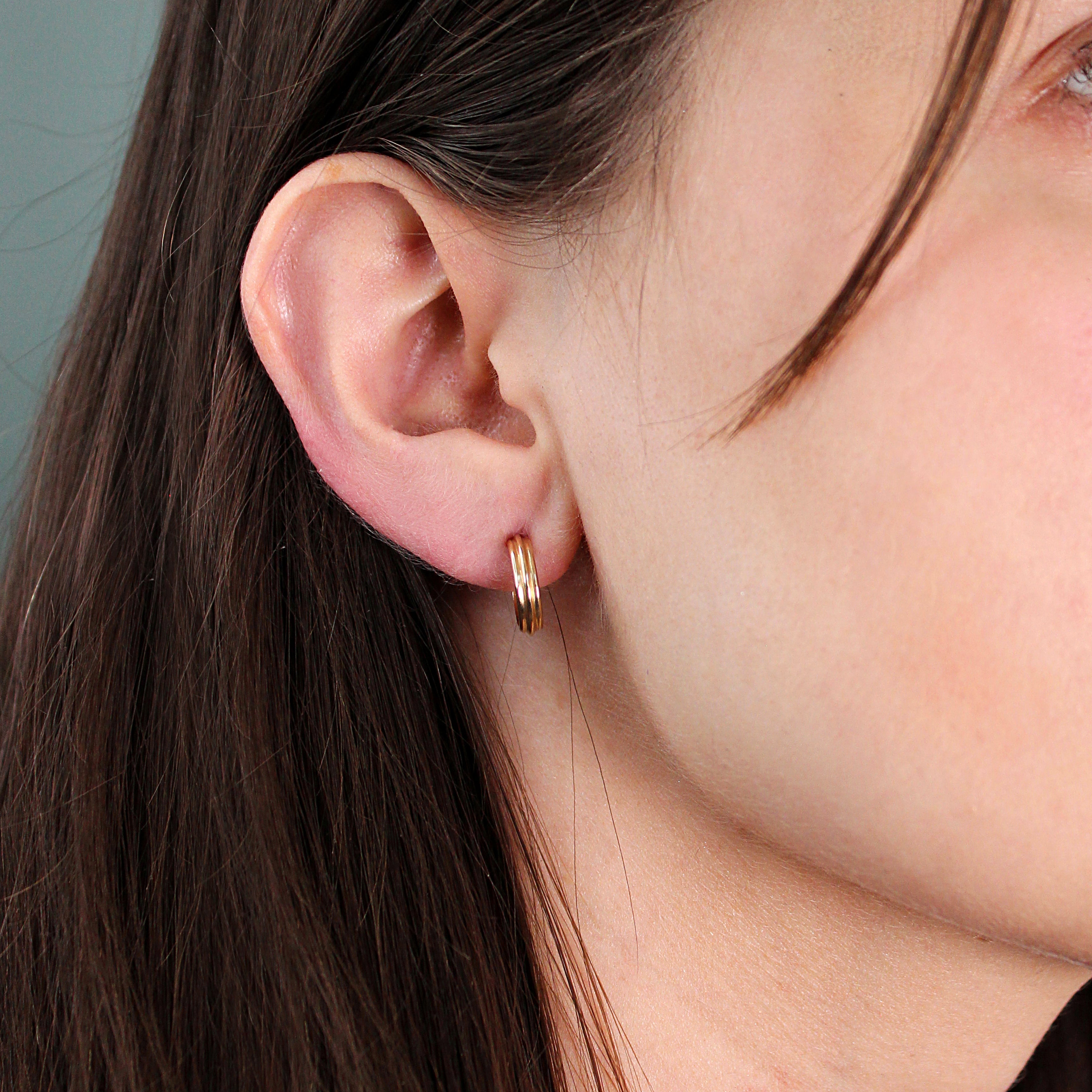 Model wears Cornice Hoop by Goldpoint Jewelry in ear