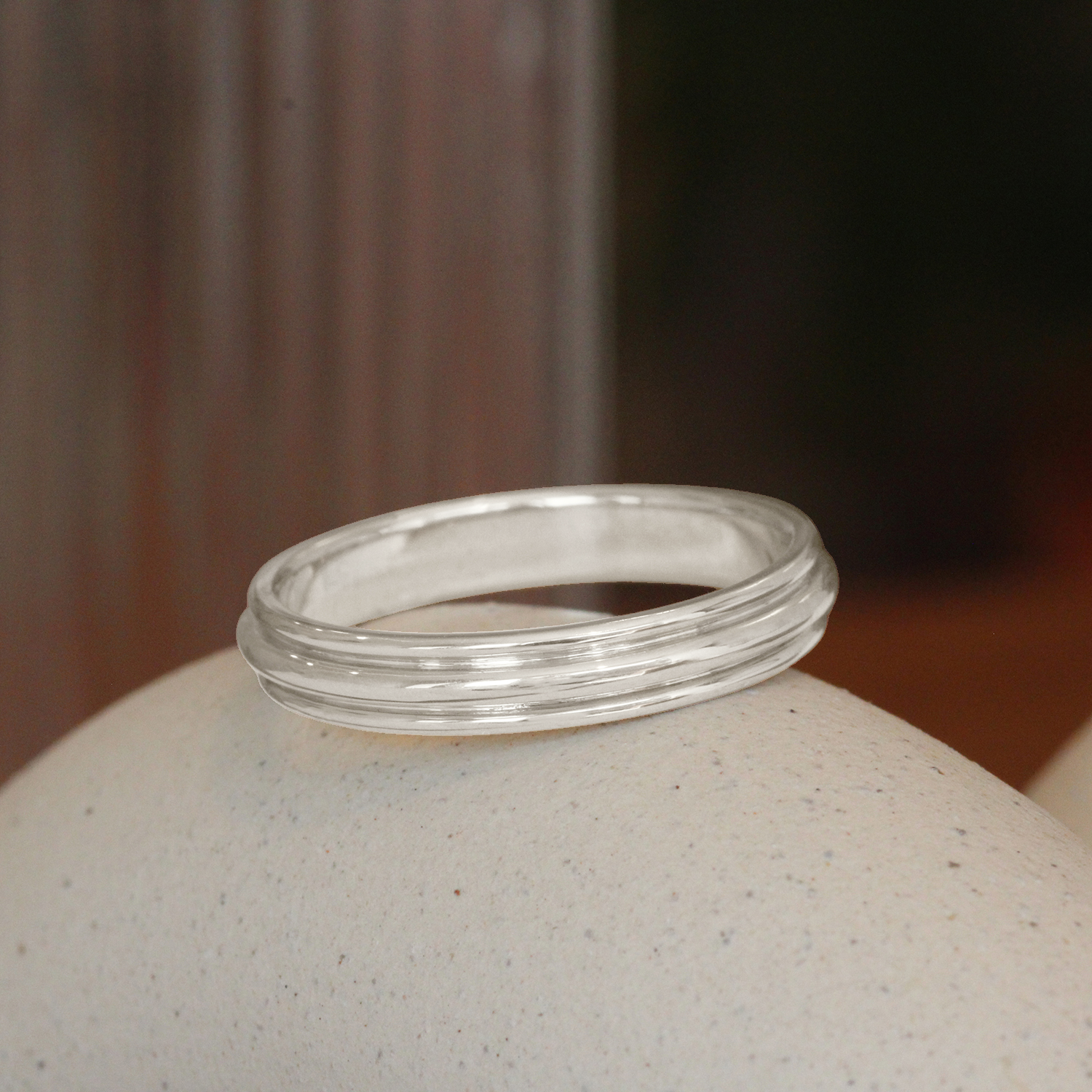 Lifestyle angled view of Cornice Band in Platinum