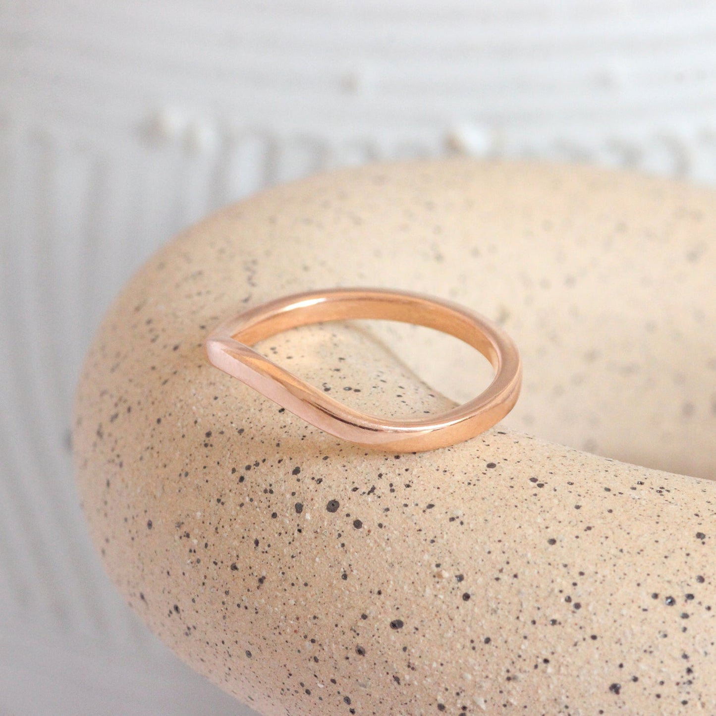 Lifestyle shot with side angle of Curve Flat Band / Standard + 14k Rose Gold