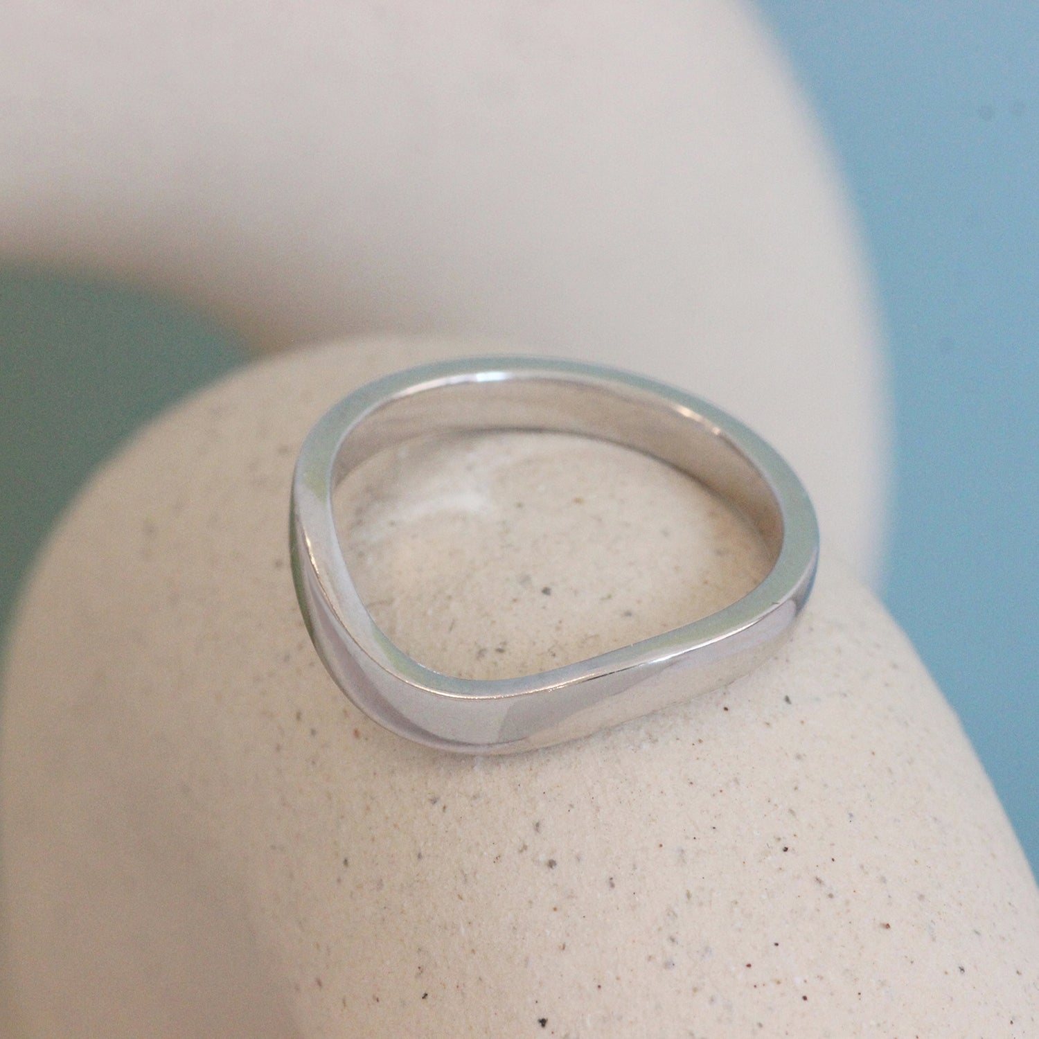 Angled lifestyle view of Flat Wide Band Deep Curve in platinum