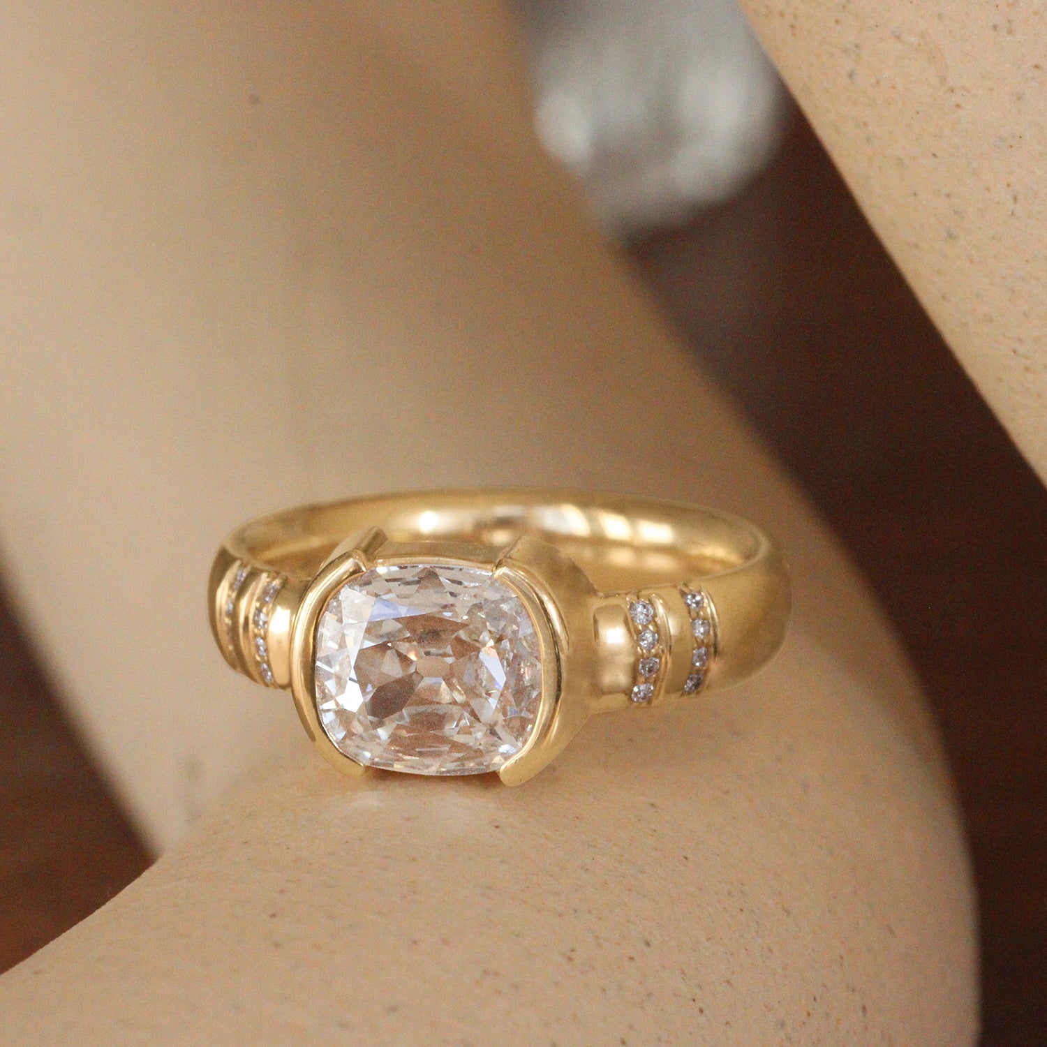 Lifestyle angled view of Dobbin Ring Antique Oval Cushion Diamond 1.28ct by Goldpoint Jewelry on a ceramic