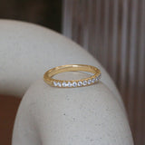 Lifestyle angled view of Dome Band Thick 2mm / Pave Round Natural Diamonds / in 14k Yellow Gold by Goldpoint Jewelry on a ceramic with blurred background