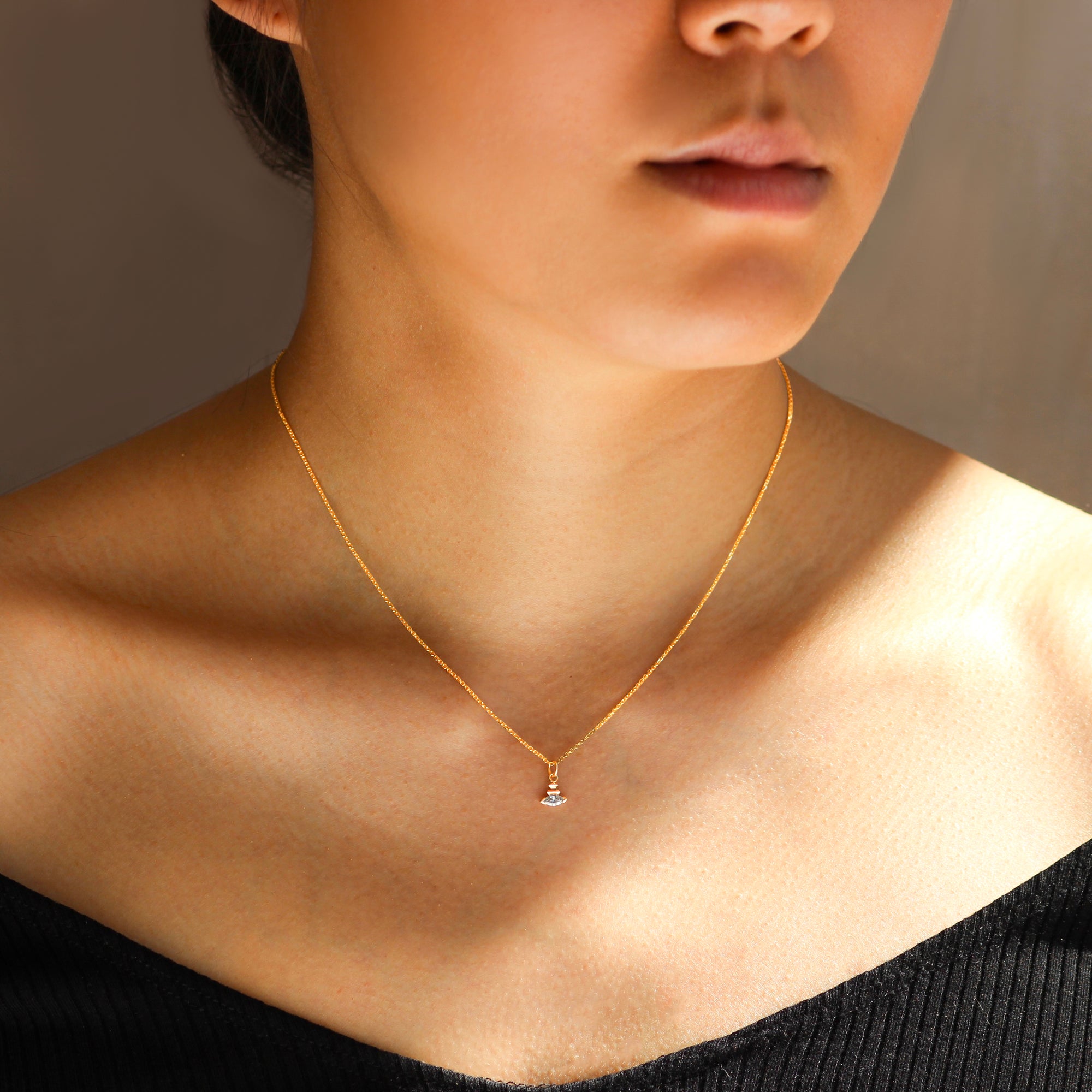 Model wears Edge Charm / Lab Marquise Diamond on a thin chain by Goldpoint Jewelry