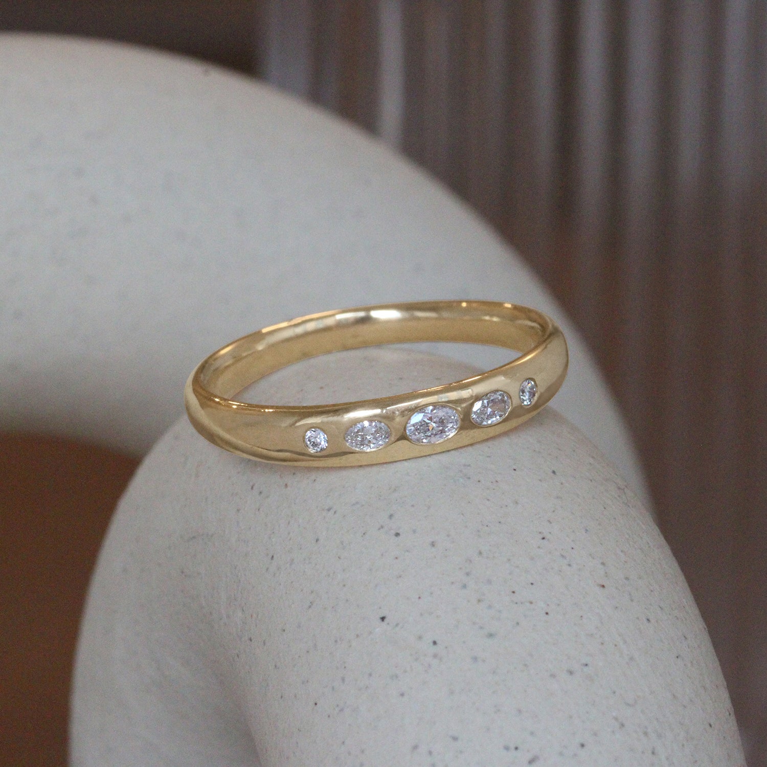 Lifestyle angled view of Ellipse Band 4mm / Flush Oval Round Lab Diamonds / in 14k Yellow Gold by Goldpoint Jewelry