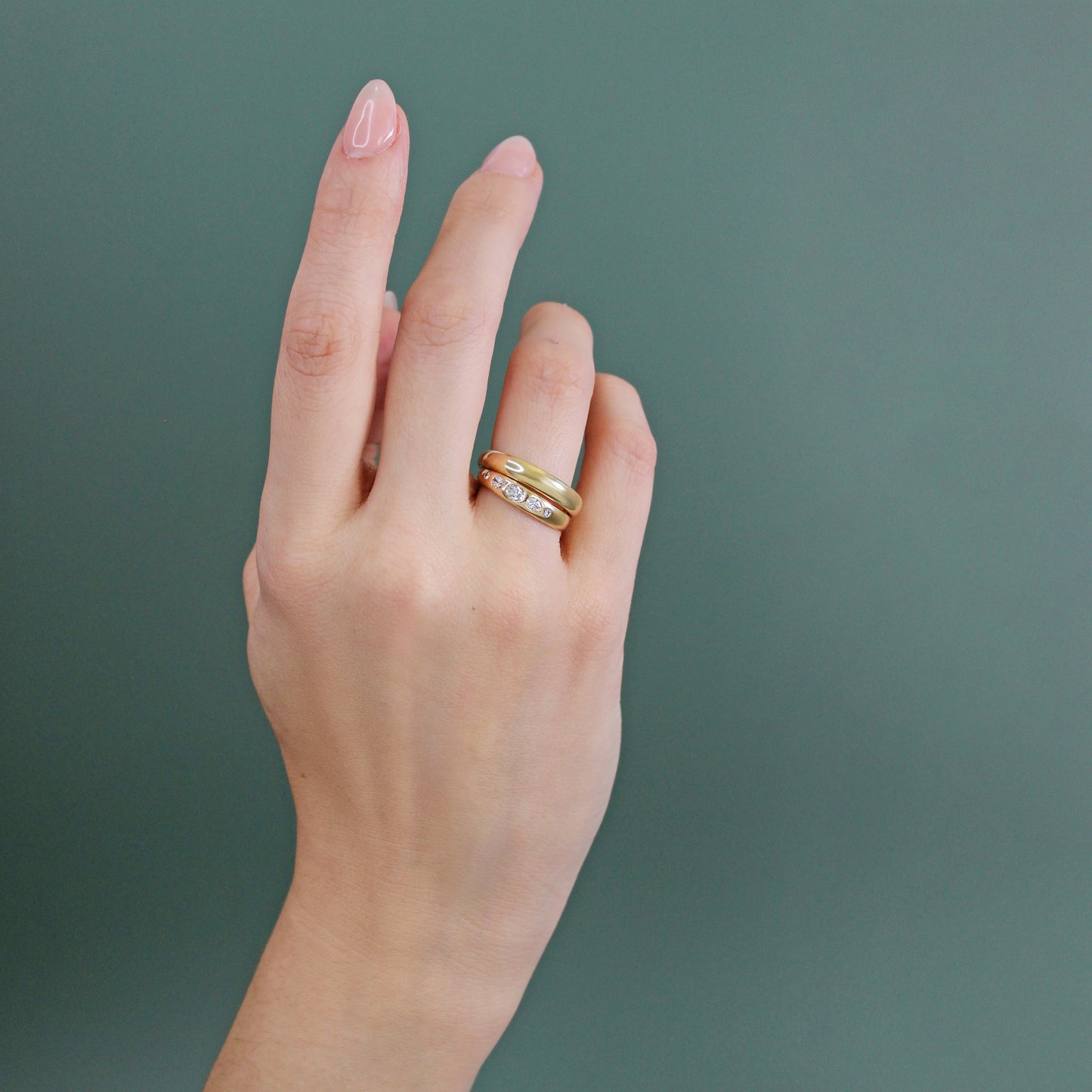Model wearing Ellipse Band / Medium with Ellipse Diamond engagement ring on ring finger