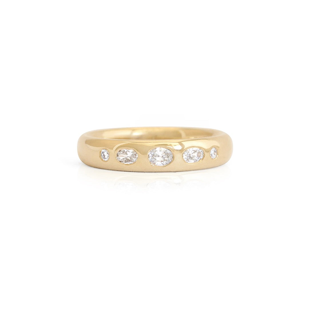 A men's gold and diamond wedding band.