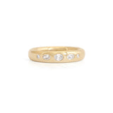 A men's gold and diamond wedding band.
