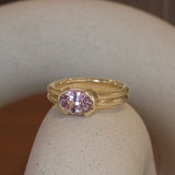 Lifestyle view of Franklin Ring Oval Sapphire 2.11ct by Goldpoint Jewelry on a ceramic with a blurred background