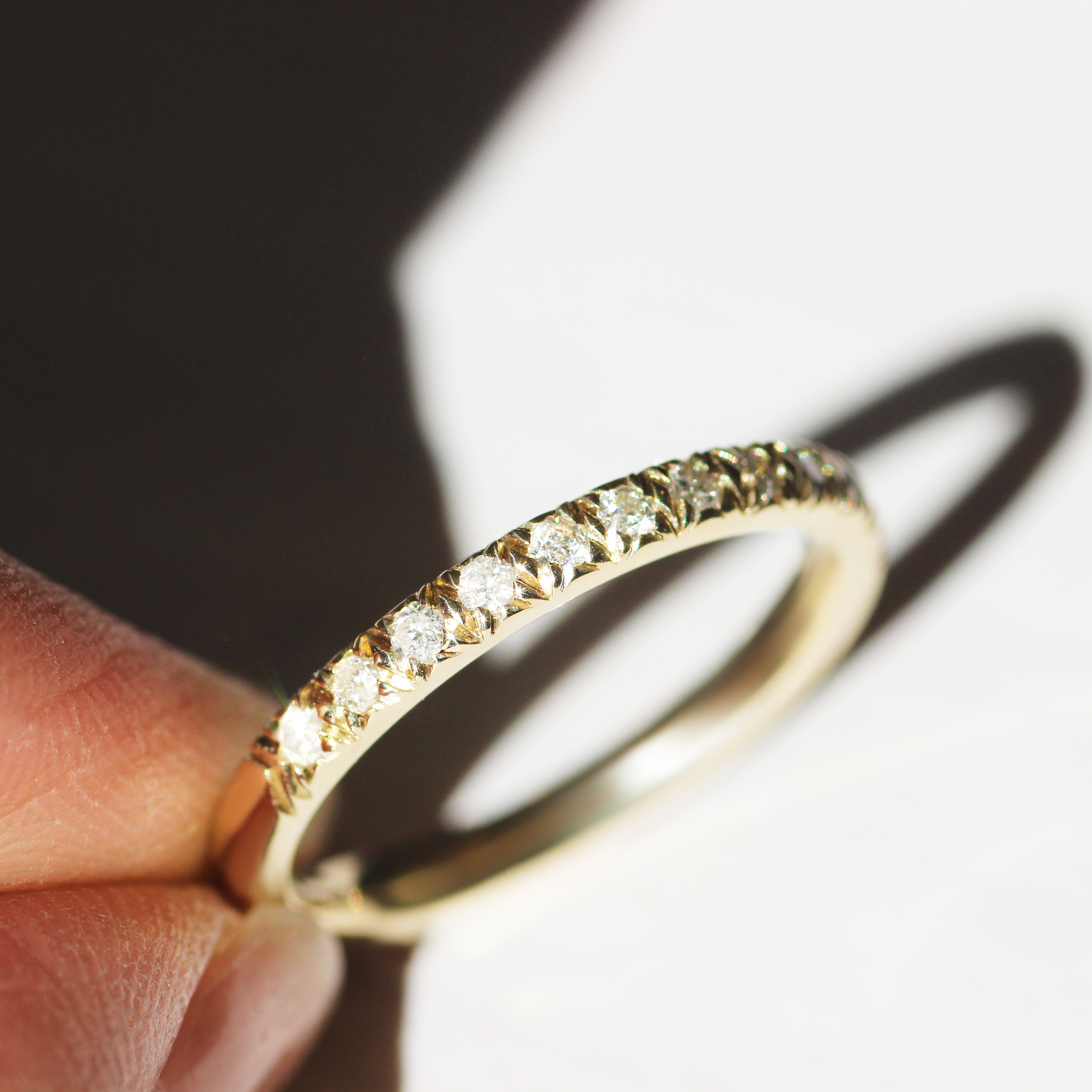 Model holds Dome Band Thick 2mm / Pave Round Lab Diamonds / 14k in Yellow Gold by Goldpoint Jewelry in hand
