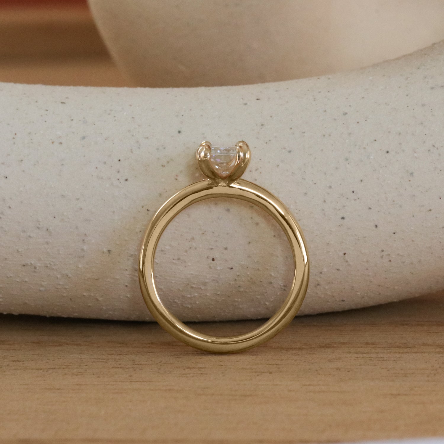 Lifestyle side profile view of Calyer Ring Radiant Lab Diamond 1ct by Goldpoint Jewelry on a ceramic with natural background