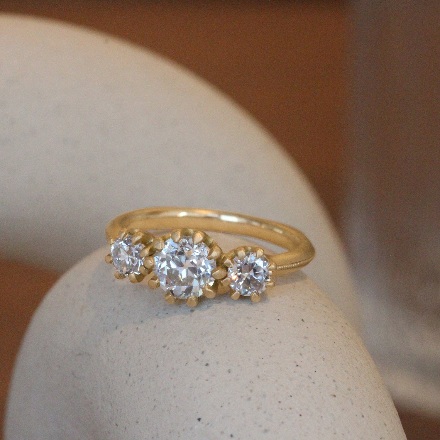 Lifestyle angled view of Grand Trio Milgrain Ring / Natural Old Euro Diamonds 1.04ct by Erin Cuff on a ceramic with a blurred background