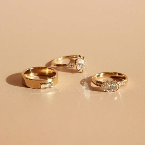 Group shot of Horizon Band / Skinny Baguette Diamond, Ellipse Ring / Oval Diamond, and Bosc Ring / Oval Diamond