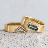 Lifestyle stacked view of Kingsland Ring Emerald Cut Sapphire 1.2ct in 14k yellow gold stacked on another ring by Goldpoint Jewelry on a ceramic